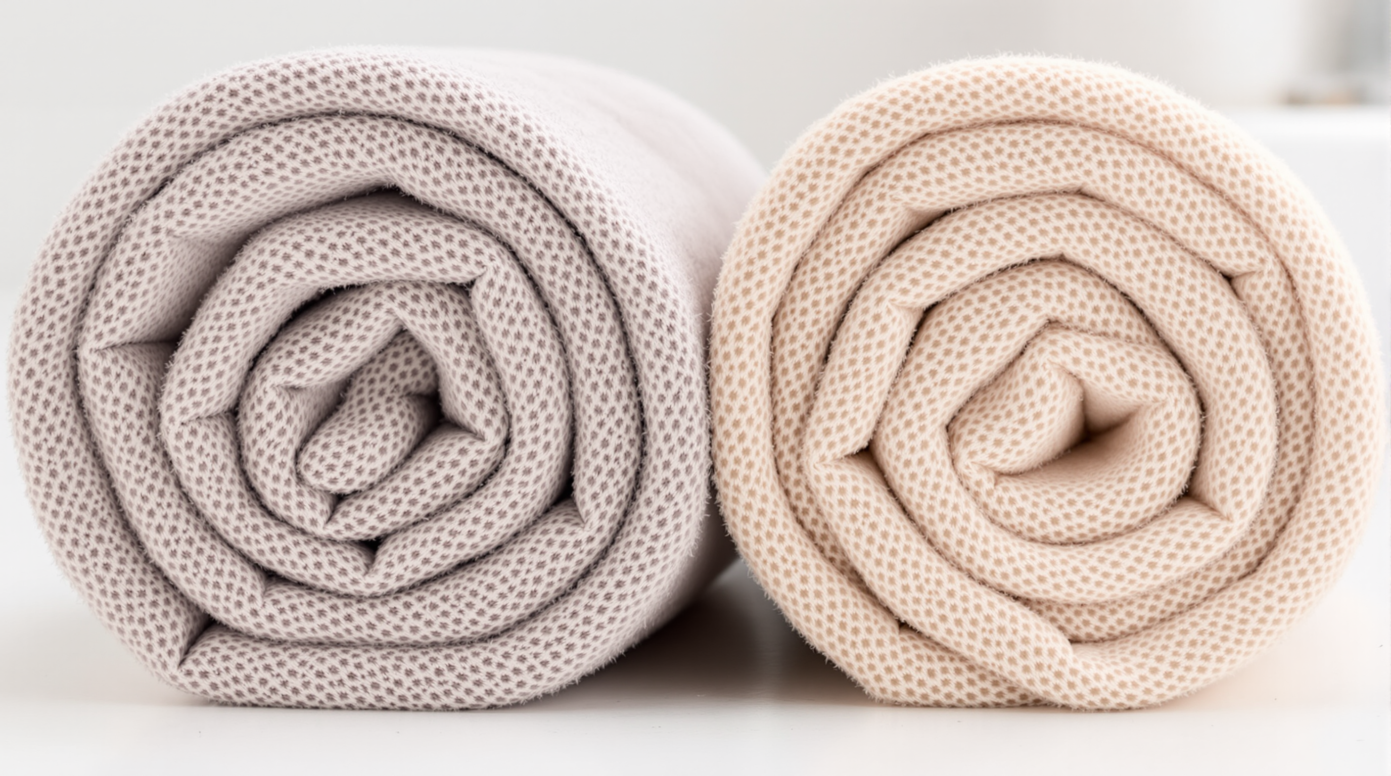 Two separate, clean towels in a bathroom, symbolizing the importance of personal hygiene and not sharing items to prevent HPV transmission.