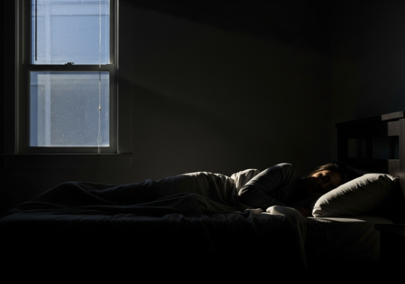 A person getting restful sleep, symbolizing its importance for reducing inflammation and healing acne.